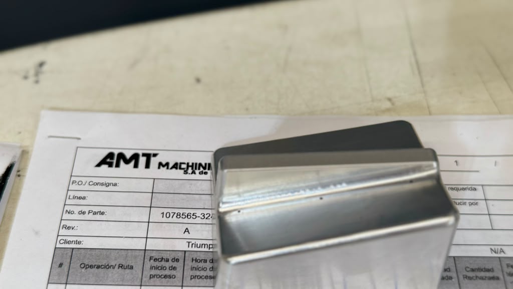 Close-up of a precision machined metal component produced by AMT Machining
